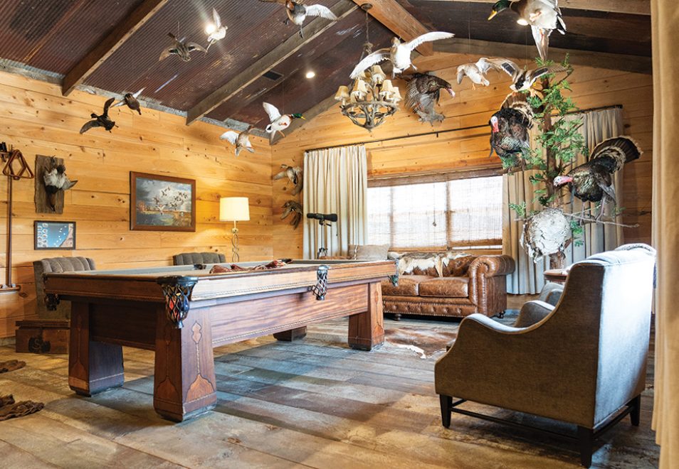 The lodge’s game room (known onsite as “the duck room”) features a 1924 pool table that came from a house in Greenville, dirty top pine flooring from an old mill in the Delta, tin reclaimed from an old barn, and the joist reclaimed from an old house Bowman tore down in Madison County.
